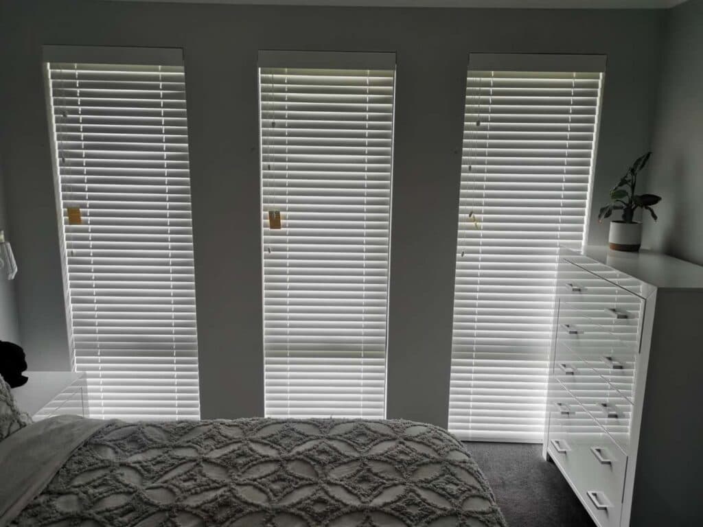Panel blinds covering large windows and sliding doors